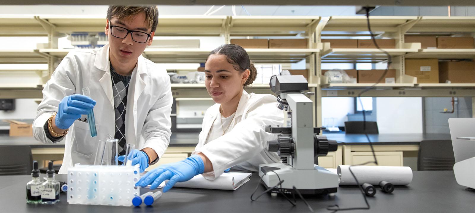  Microbiology student Using microscope.